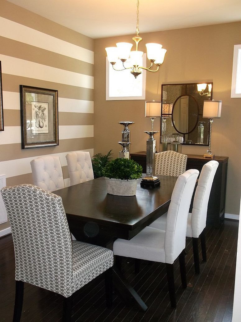 Traditional dining room with a striped accent wall …