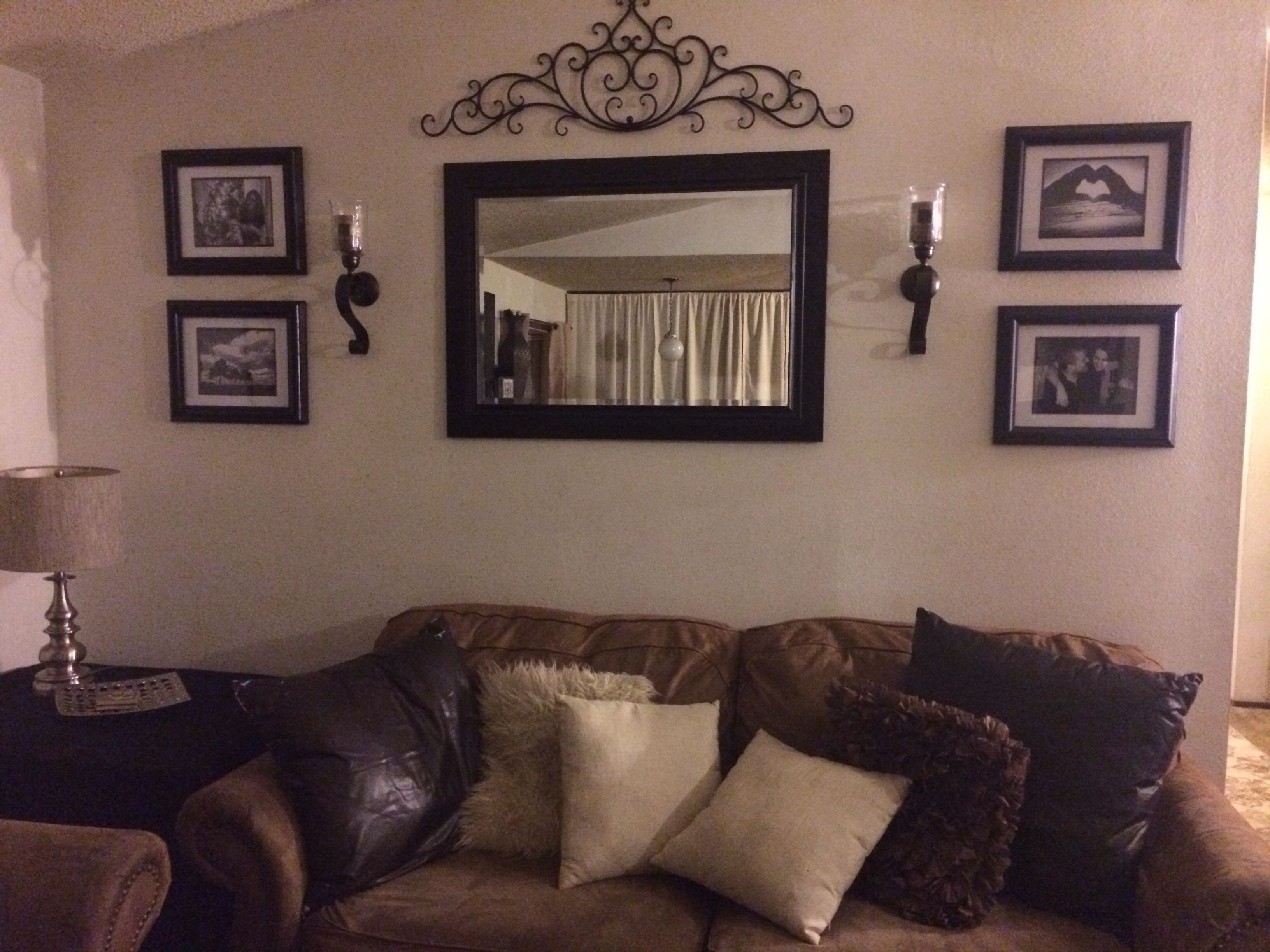 behind couch wall in living room mirror frame sconces